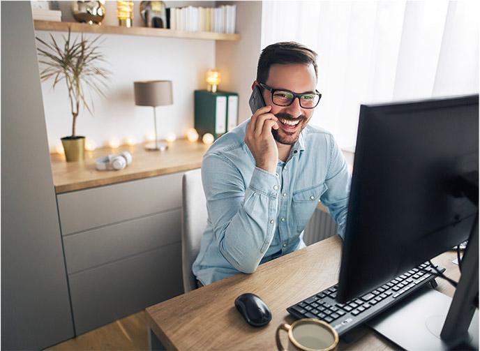 Man on the phone at his desk